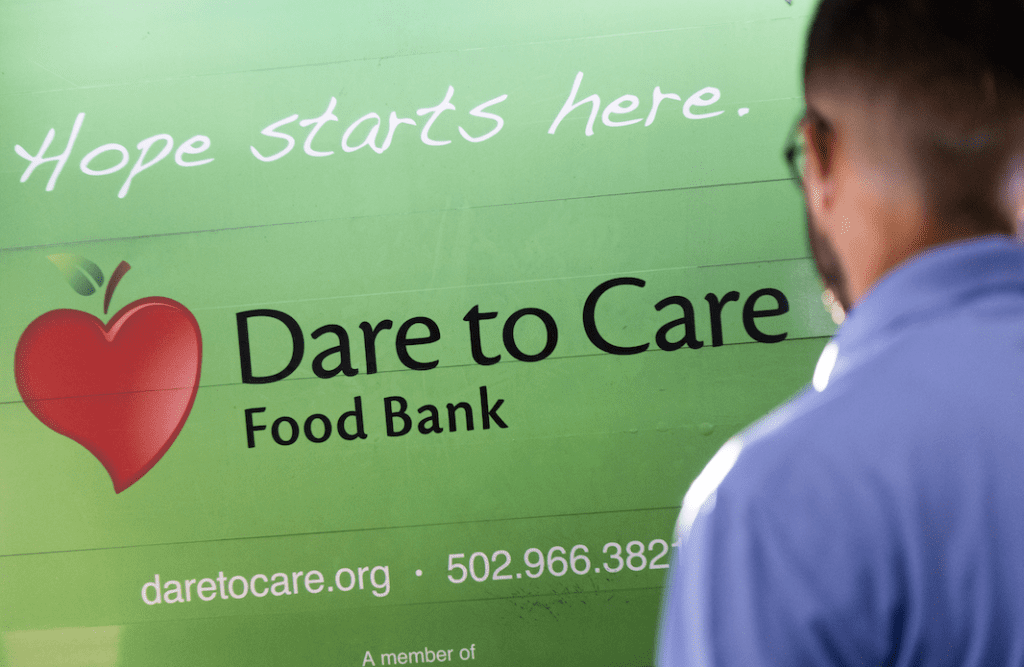 Main in front of dare to care sign